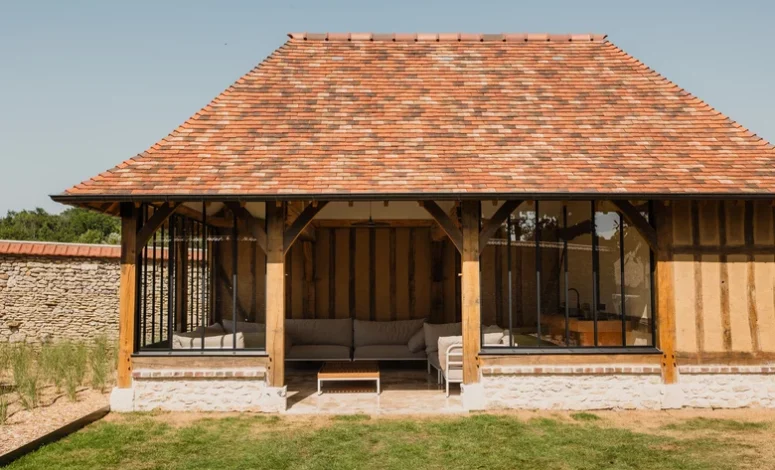 Bâtiment à colombages avec terrasse couverte en Normandie