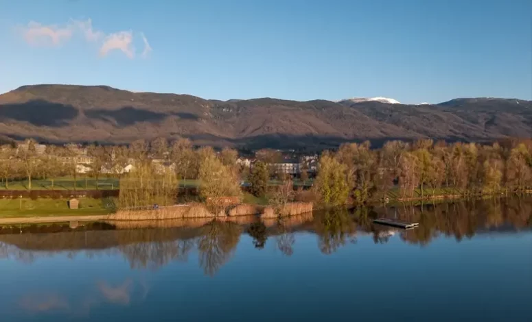 Vue sur un lac entouré d’arbres et de montagnes, pour un séminaire au vert près de Genève et d’Annecy
